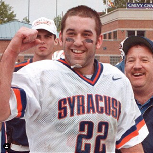 A man in white jersey holding up two fingers.