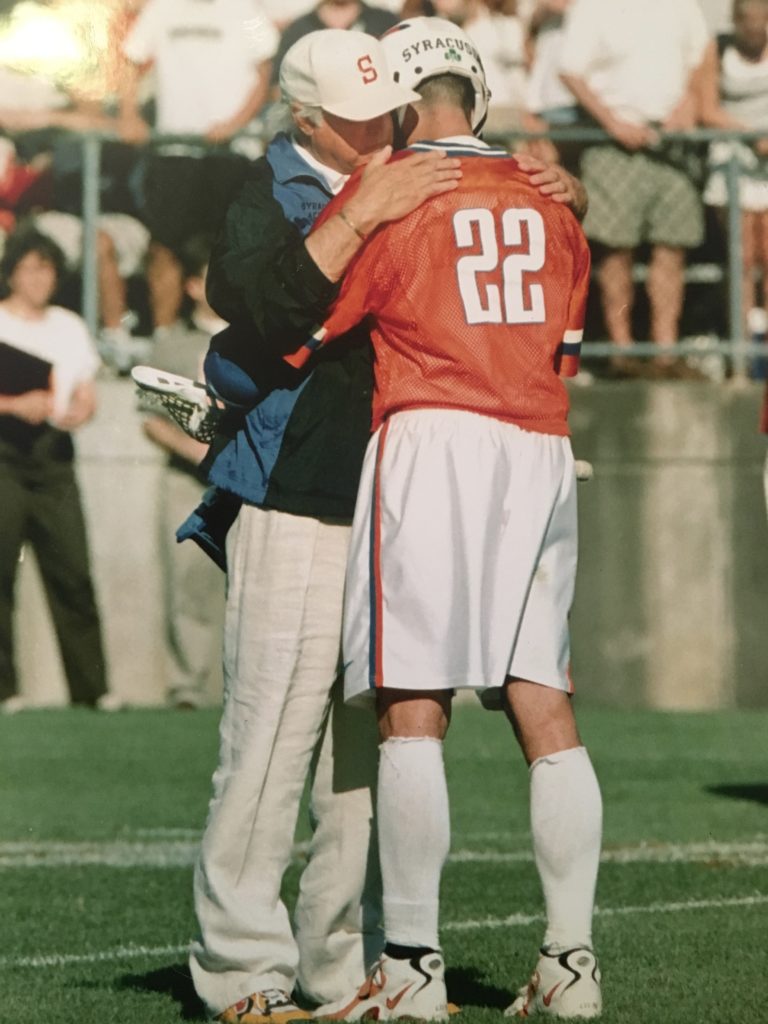 A couple of people that are hugging on the field