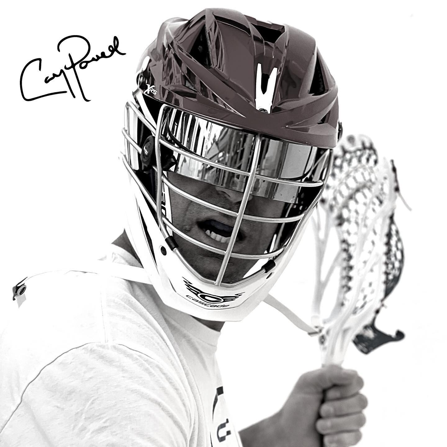 A lacrosse player wearing a helmet and holding a stick.